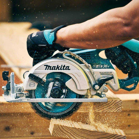 Close-up action shot of a professional framer using the Makita 18V X2 LXT rear handle saw to slice through a stack of SPF lumber, highlighting the high-torque performance and effective dust clearing.