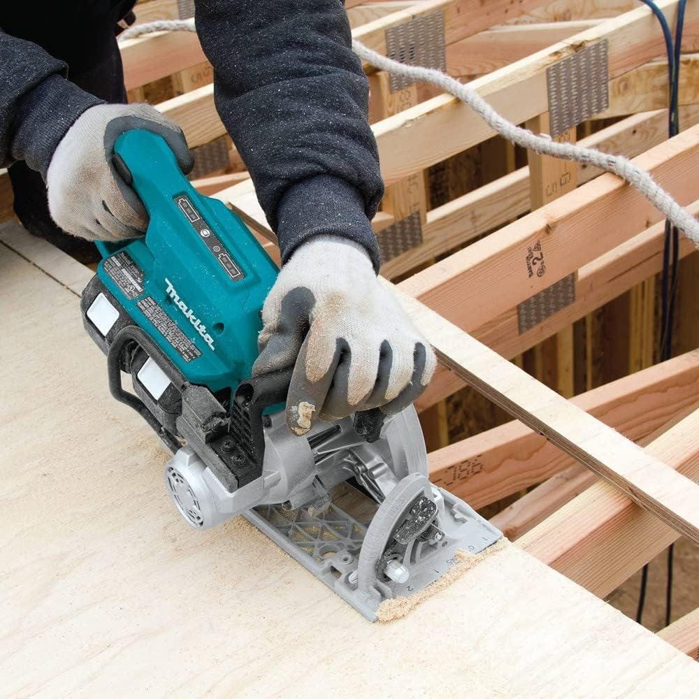 A worker utilizing the Makita XSR01 brushless circular saw to rip-cut structural OSB sheathing, demonstrating the tool's corded-power performance and maneuverability in framing applications.