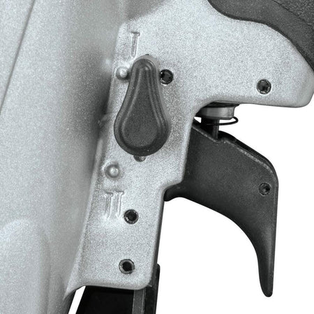Close-up of the trigger and black mode selector switch on the Makita AN924 framing nailer's handle.