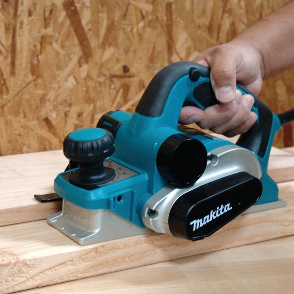 Makita electric planer being used on a wooden surface