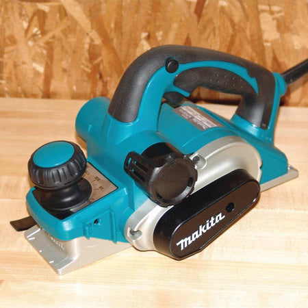 Makita electric planer on a wooden surface