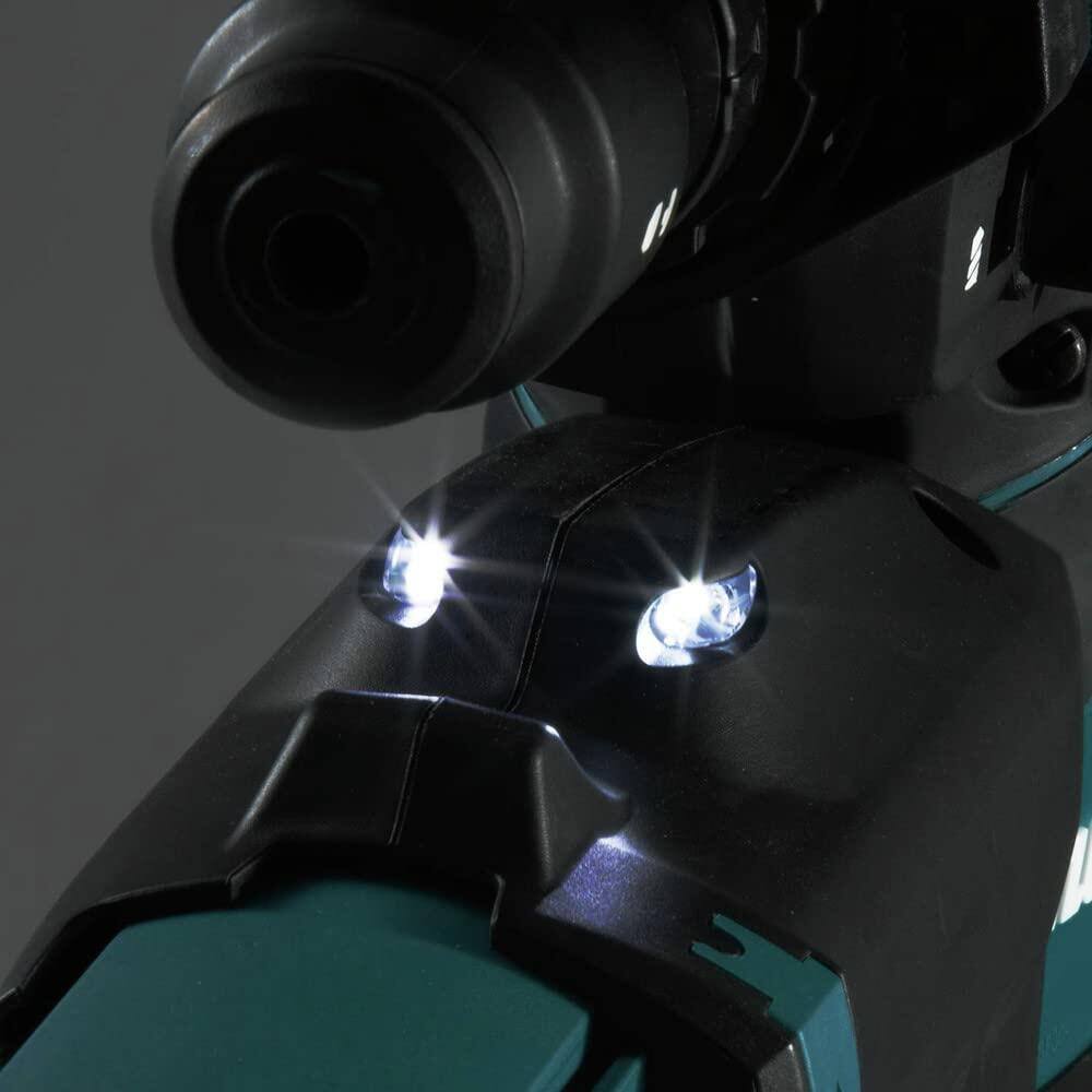 Close-up of Makita rotary hammer drill with dual LED work lights illuminated; teal and black casing with drill bit partially visible, designed for low-light precision.