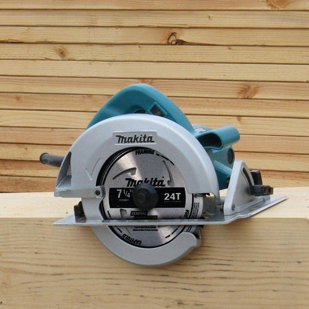 Isolated view of the Makita 5007FA corded circular saw resting on a wooden board, showcasing the 7-1/4 inch blade and adjustable bevel scale.