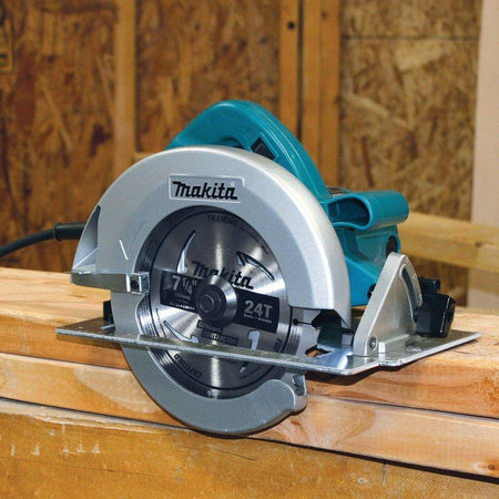 Action shot of the Makita 5007FA corded circular saw resting on dimensional lumber, showcasing the 24T framing blade and professional build quality.