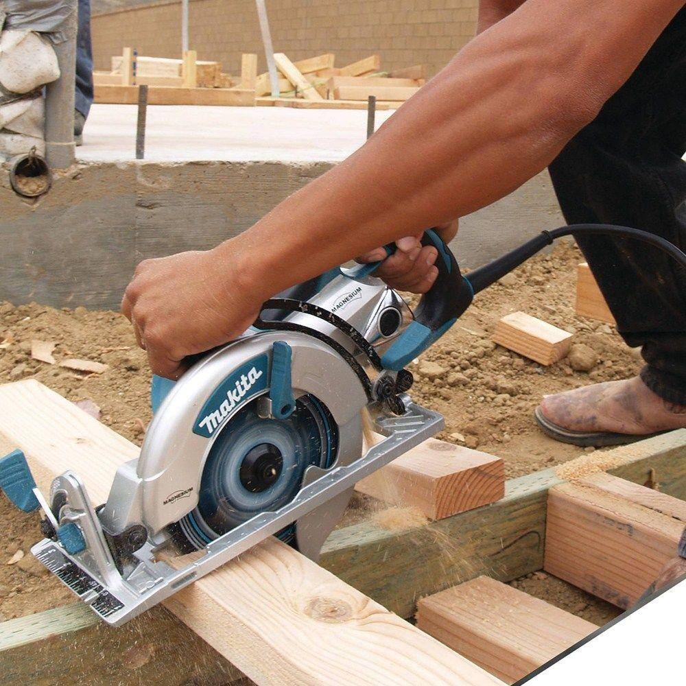 A professional builder in safety gear guiding the Makita 15 AMP hypoid saw through a long rip cut on a wooden board, showcasing the tool's power and efficiency for general contractors.