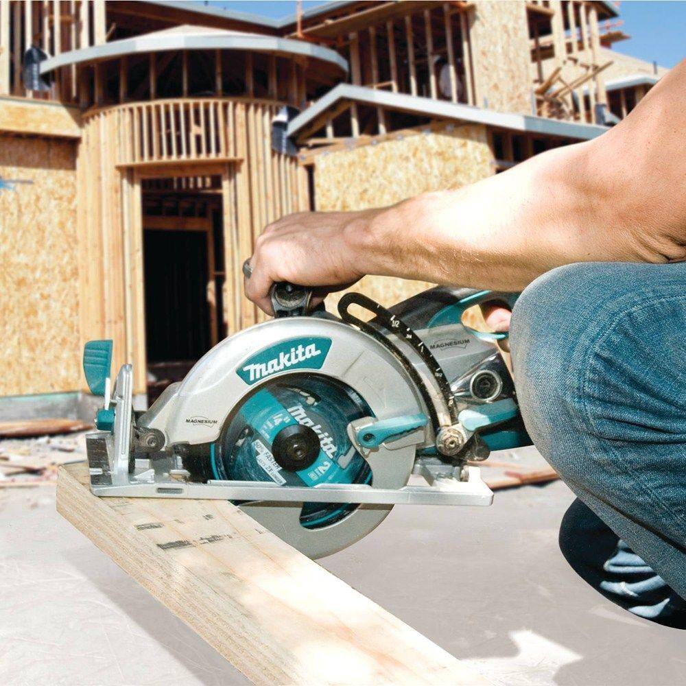 A professional builder in safety gear guiding the Makita 15 AMP hypoid saw through a long rip cut on a wooden board, showcasing the tool's power and efficiency for general contractors.