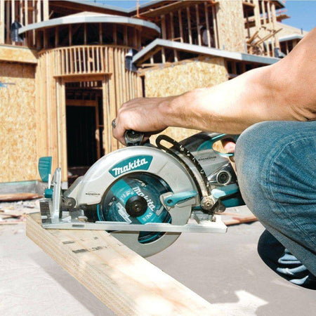 A professional builder in safety gear guiding the Makita 15 AMP hypoid saw through a long rip cut on a wooden board, showcasing the tool's power and efficiency for general contractors.