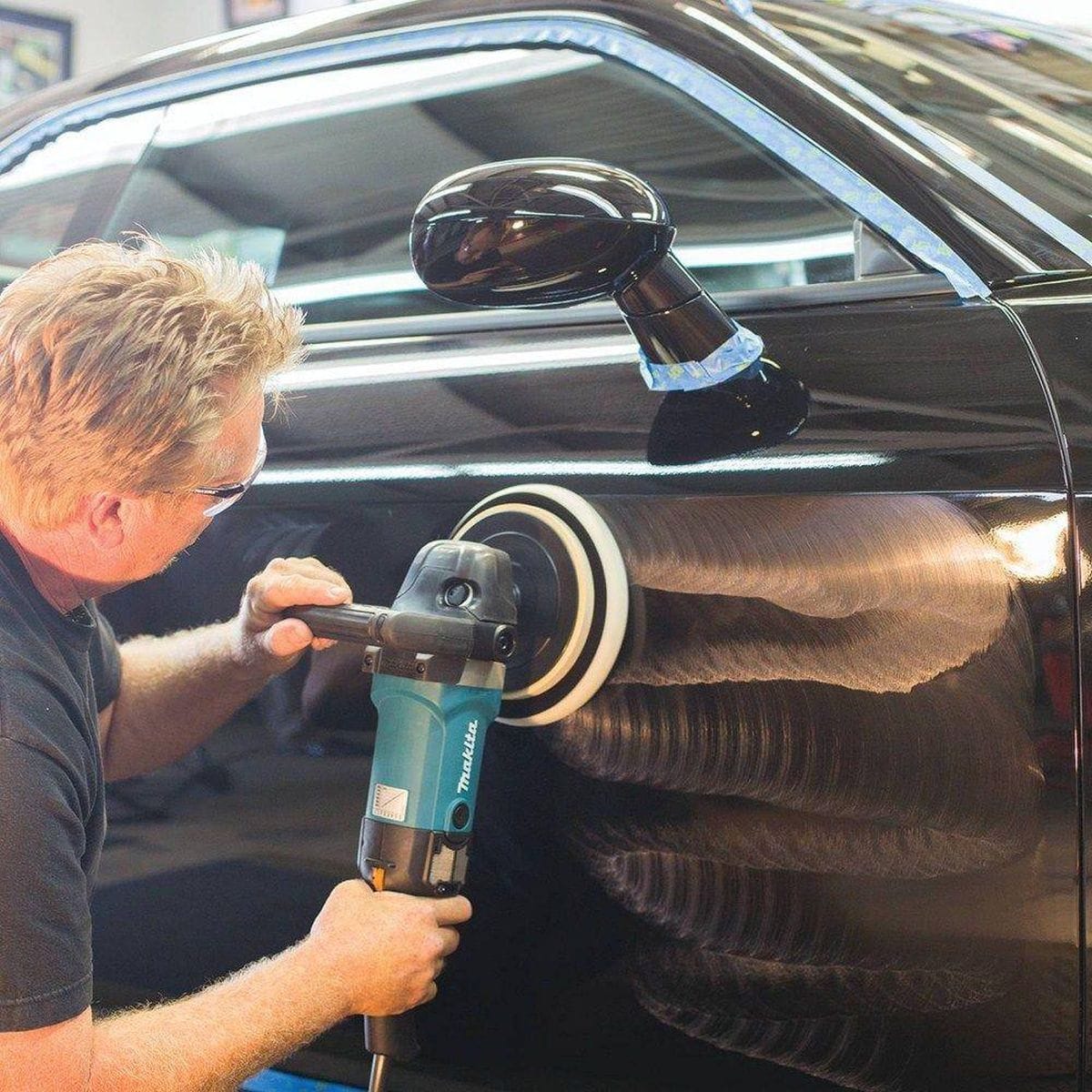 Side profile graphic of the Makita professional polisher highlighting the integrated safety and durability features, including the robust cord guard and the protective wire mesh intake covers.