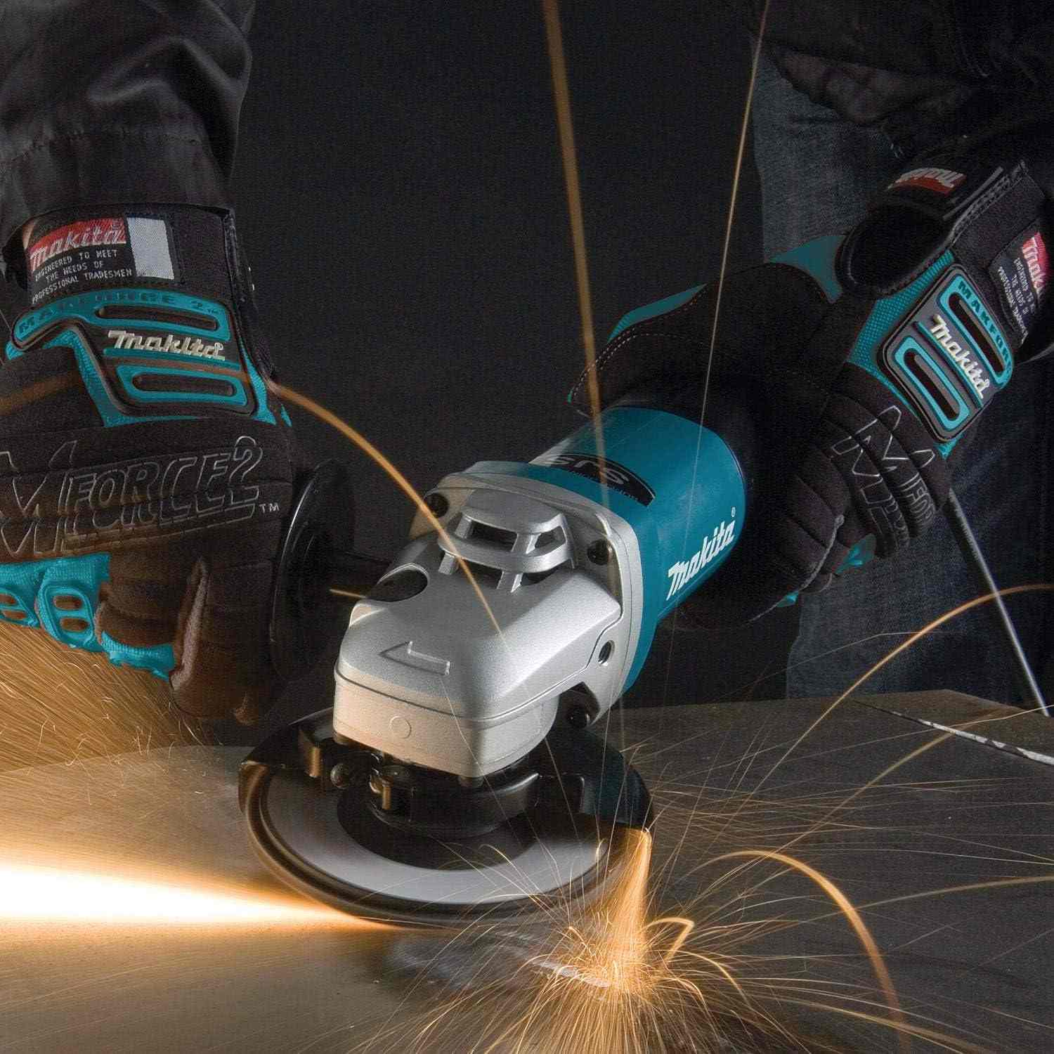 An action-oriented perspective of the Makita 9565PCV angle grinder with a paddle switch being used on a metal surface, emphasizing the ergonomic grip and high-torque capability.