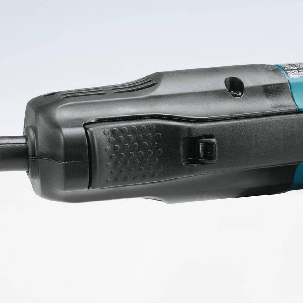 A detailed view of the large high-power paddle switch located on the body of the Makita angle grinder, designed for comfortable operation and enhanced jobsite safety.