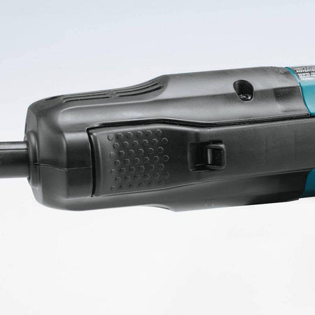 A detailed view of the large high-power paddle switch located on the body of the Makita angle grinder, designed for comfortable operation and enhanced jobsite safety.