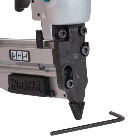 Extreme close-up of the narrow nose design on the Makita AF353 23 gauge pin nailer, engineered for easy nailing access in tight areas for finish carpentry.