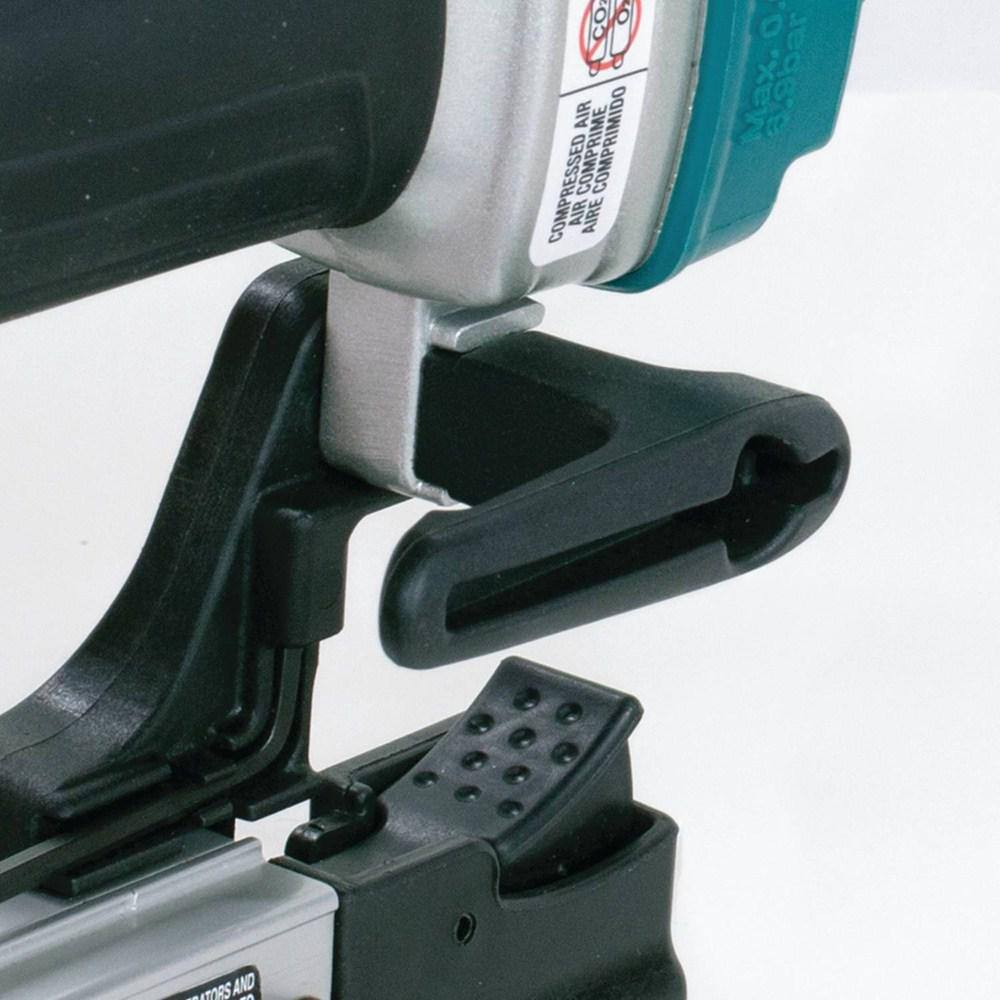 Detailed view of the reversible belt hook on the Makita AF353 23 gauge air powered pin nailer, allowing the tool to remain conveniently close by during cabinet construction.