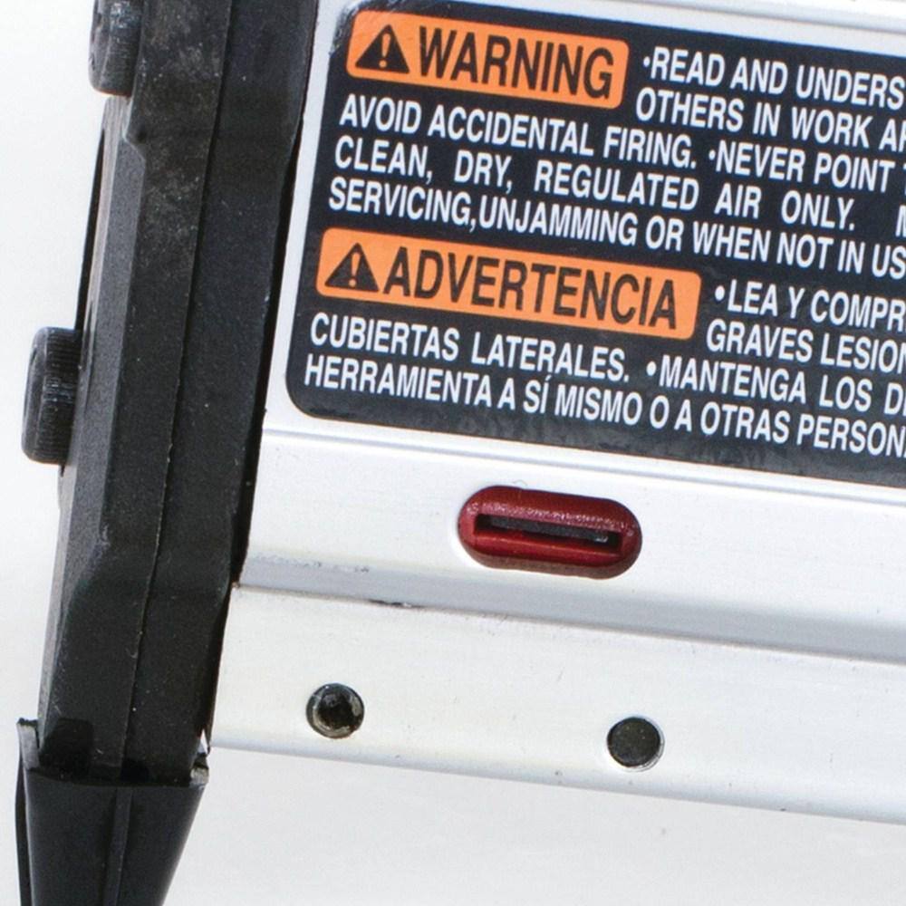 Close-up of the red nail lock-out window indicator on the Makita AF353 pin nailer magazine, alerting the woodworker when to reload 23 gauge pins to prevent dry-fires.