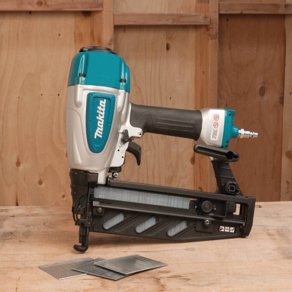 Makita nail gun on a wooden surface with a wooden background
