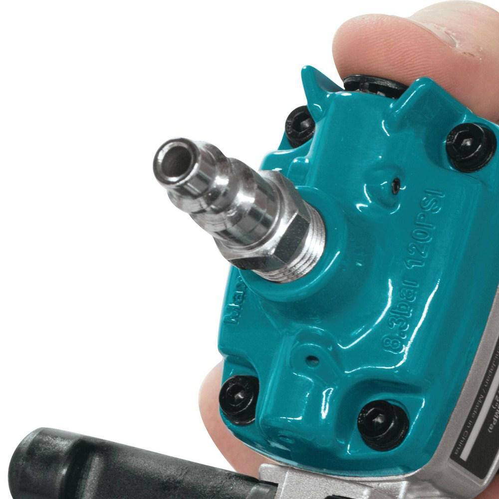 Close-up of a user adjusting the tool-less depth adjustment dial on the Makita AF601 finish nailer for precise flush or countersink nailing.