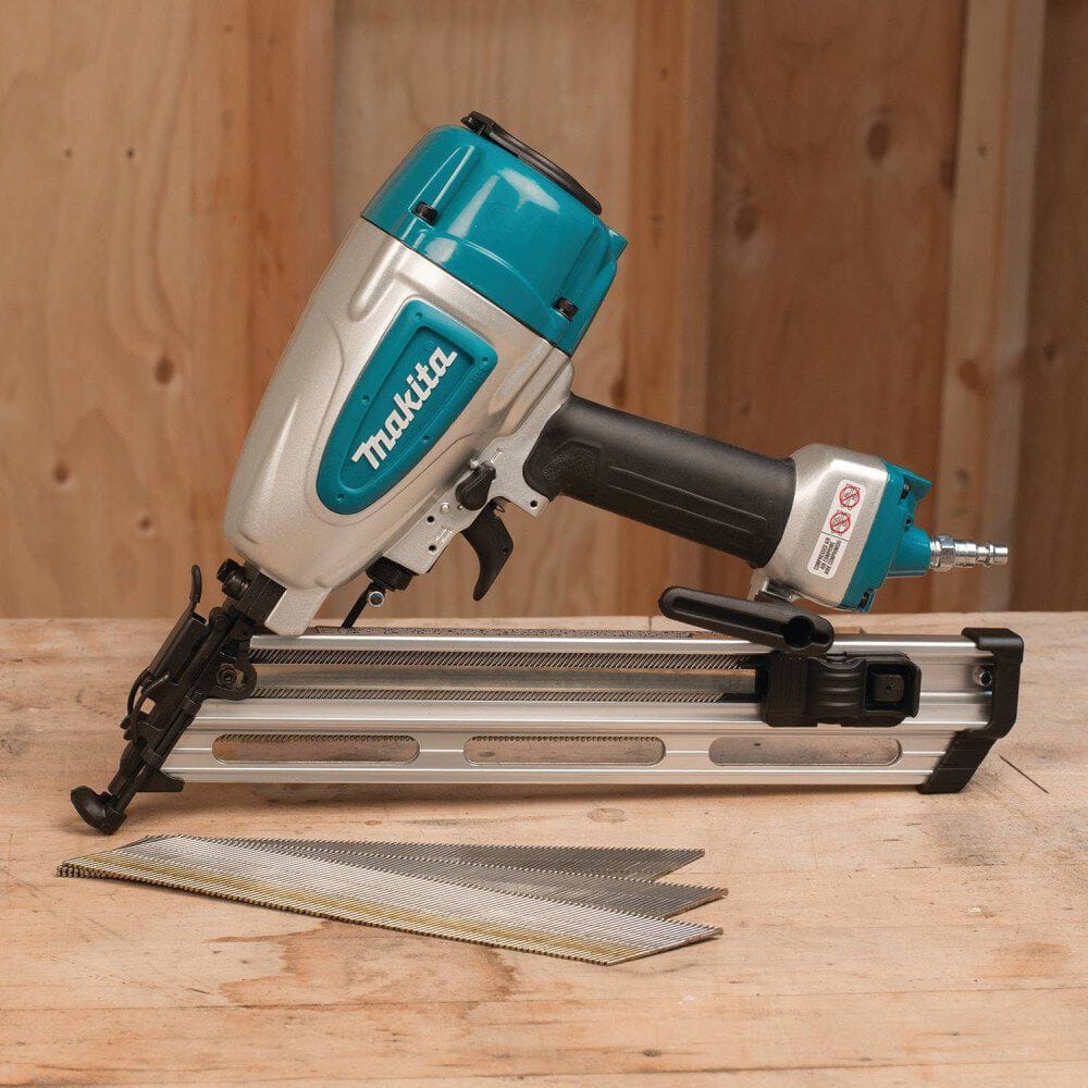 Makeita nail gun on a wooden surface with a wooden background