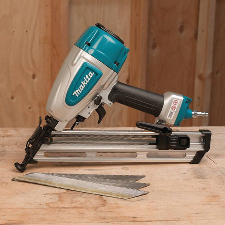 Makeita nail gun on a wooden surface with a wooden background
