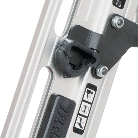 Close-up of a thumb pressing the built-in air duster button on the Makita AF635 pneumatic angled finish nailer to quickly clear sawdust and debris from a workspace.
