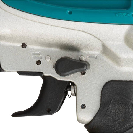 Close-up of the 2-mode selector switch on the Makita AN613 pneumatic coil nailer, allowing quick transitions between single sequential and contact actuation modes.