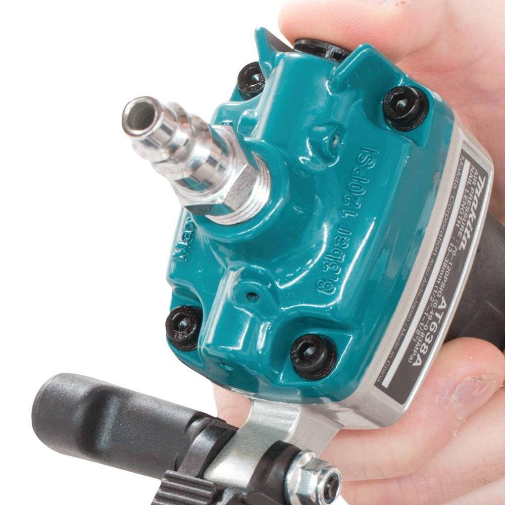 Extreme close-up of the 1/4 inch NPT air inlet on the Makita AT638A 18 gauge stapler, designed for easy connection to standard air hoses.