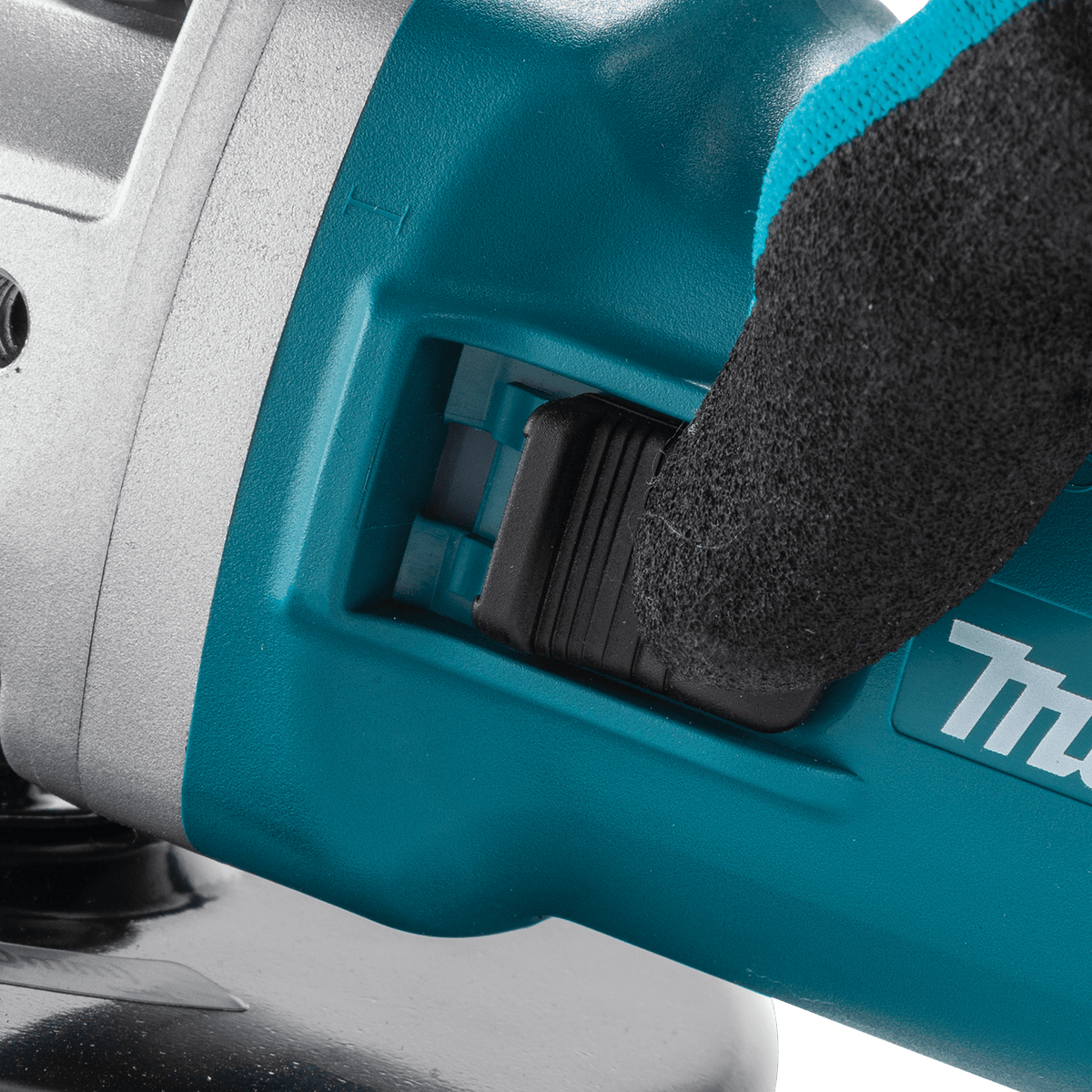 Close-up of the slide switch with lock-on feature on the Makita angle grinder for continuous, fatigue-free operation.