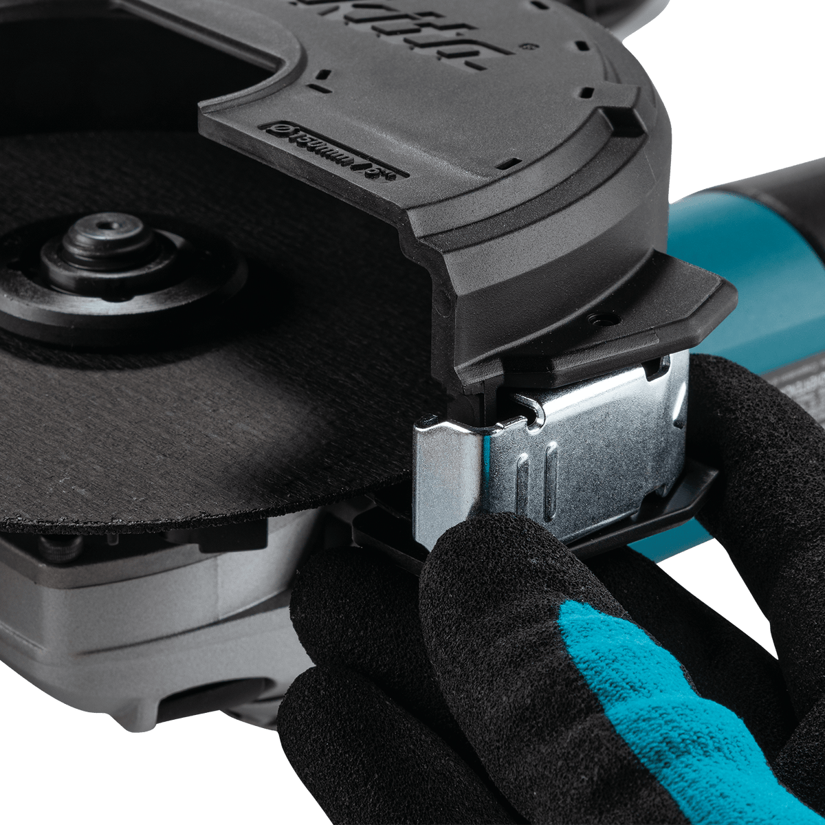 Close-up of the secure locking latch securing the clip-on cut-off wheel guard cover onto the Makita grinder housing.