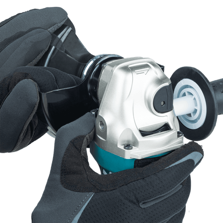 Gloved operator adjusting the rotation angle of the permanently attached non-removable wheel guard on the Makita GA4553R.