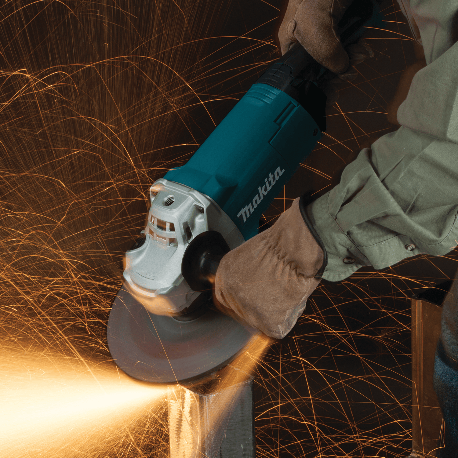 Fabricator using the 15.0A Makita GA9060 9-inch angle grinder at 6,600 RPM to bevel a heavy steel box tube.