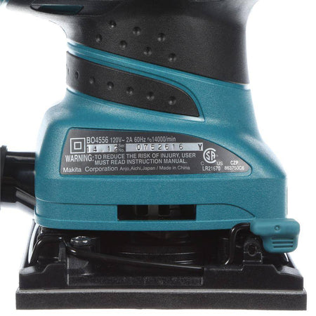 Teal and black sander with visible branding and warning labels on a white background