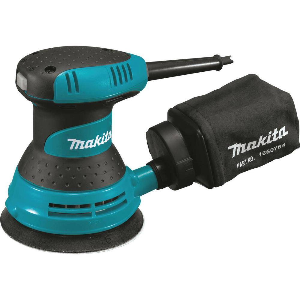 Underside view of the 5-inch hook-and-loop sanding pad on the Makita orbital sander, illustrating the 8-hole pattern for efficient through-the-pad dust extraction and rapid paper changes.