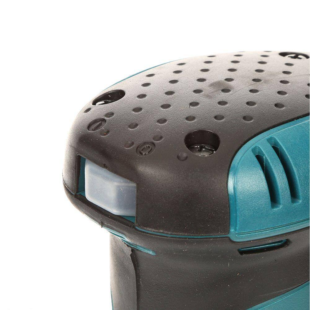 Close-up of a black and teal power tool on a white background