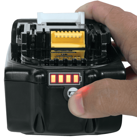 Finger pressing the battery check button on a Makita BL1850B 18V LXT 5.0Ah battery to display four illuminated LED charge bars.