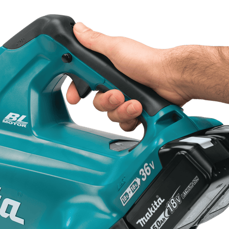 Operator holding the ergonomic soft-grip handle of the Makita XBU02 36V blower equipped with an 18V LXT 5.0Ah lithium-ion battery.