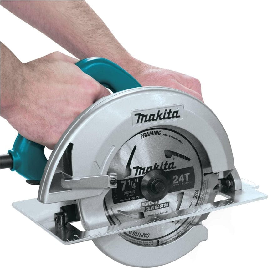 Operator hands gripping the top D-handle and front auxiliary handle of the Makita 5007F circular saw for two-handed cutting control.