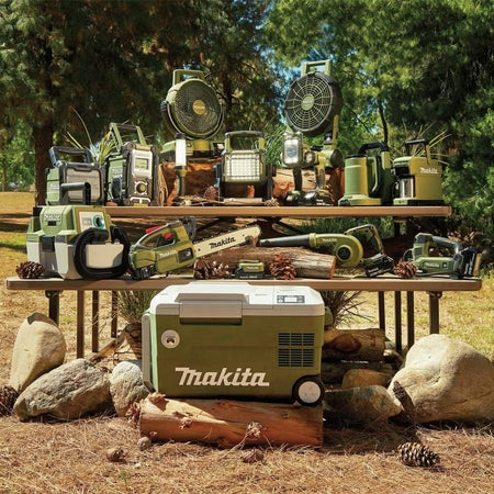 Complete Makita Outdoor Adventure 18V LXT cordless tool ecosystem setup on a park table including the ADCM501Z coffee maker.