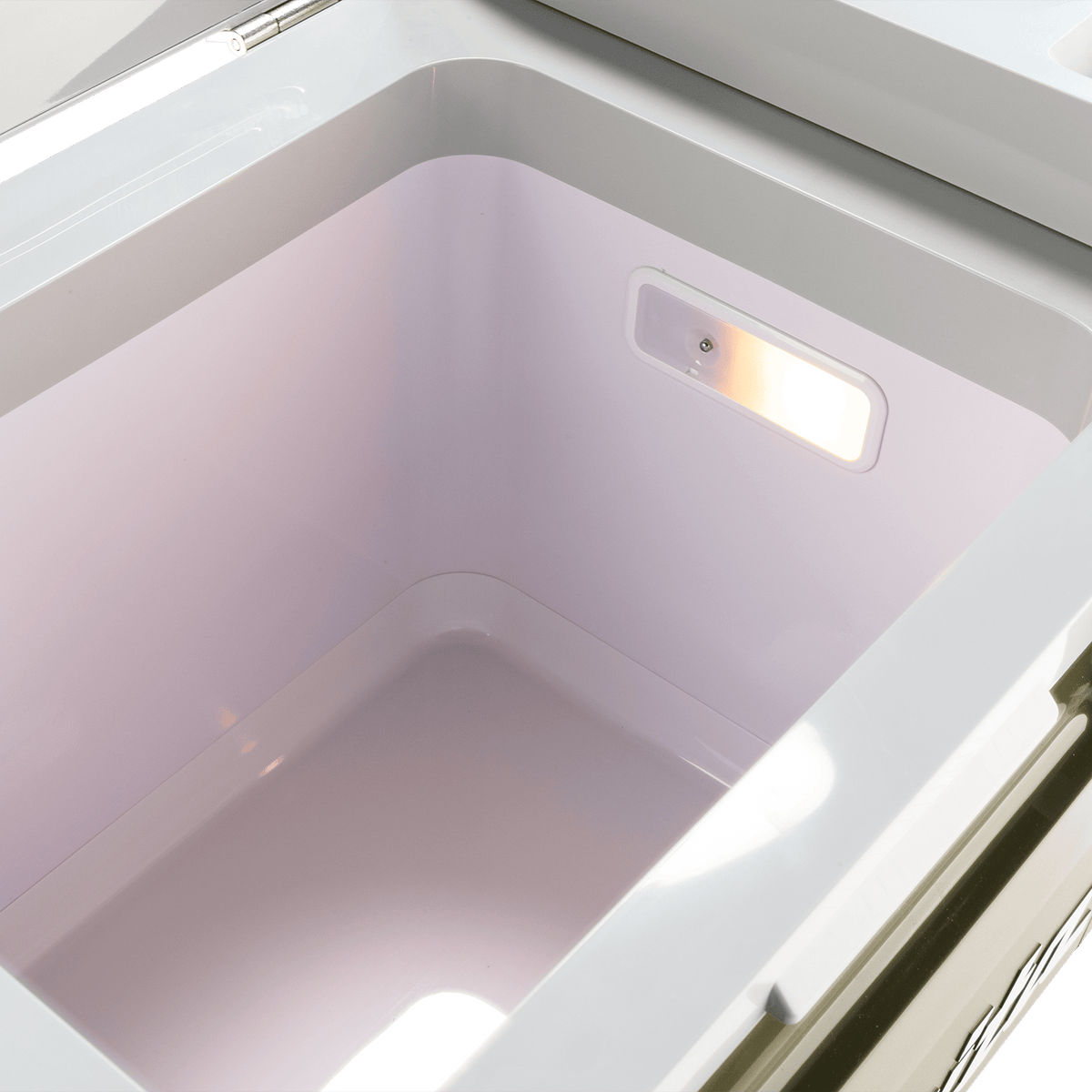Interior view of the illuminated 21-quart storage chamber on the Makita ADCW180Z cooler showing the built-in LED inspection light.