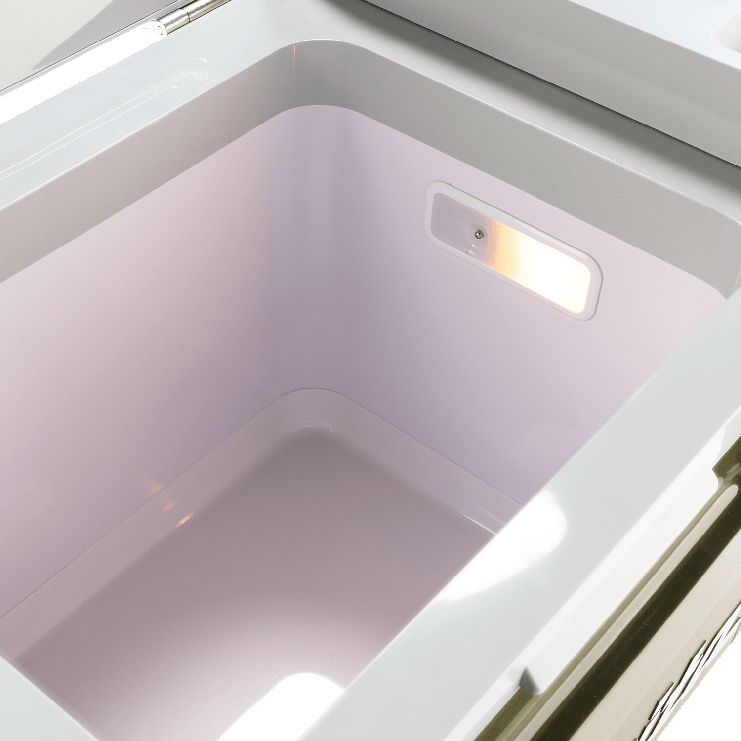 Interior view of the illuminated 21-quart storage chamber on the Makita ADCW180Z cooler showing the built-in LED inspection light.