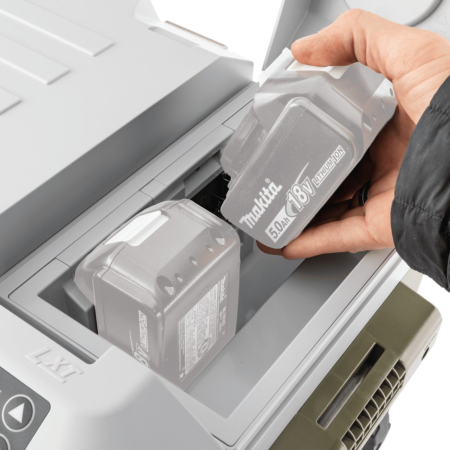 Hand inserting two 18V LXT 5.0Ah lithium-ion batteries into the top weather-sealed battery compartment of the Makita ADCW180Z cooler.