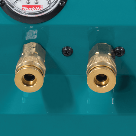 Close-up of dual 1/4-inch universal brass quick couplers on the Makita MAC2400 for simultaneous two-gun framing operation.
