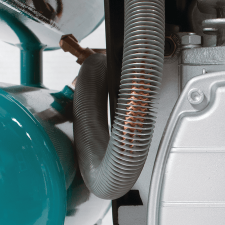 Copper-finned discharge tubing on the Makita MAC2400 compressor dissipating heat to minimize moisture buildup.