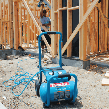 Makita MAC5200 5.2-gallon compressor delivering 6.5 CFM at 90 PSI to power overhead residential framing nailer work.