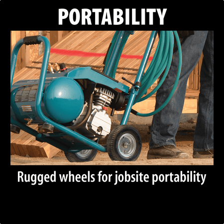 Worker transporting the wheeled Makita MAC5200 air compressor with an attached hose wrap on a jobsite.