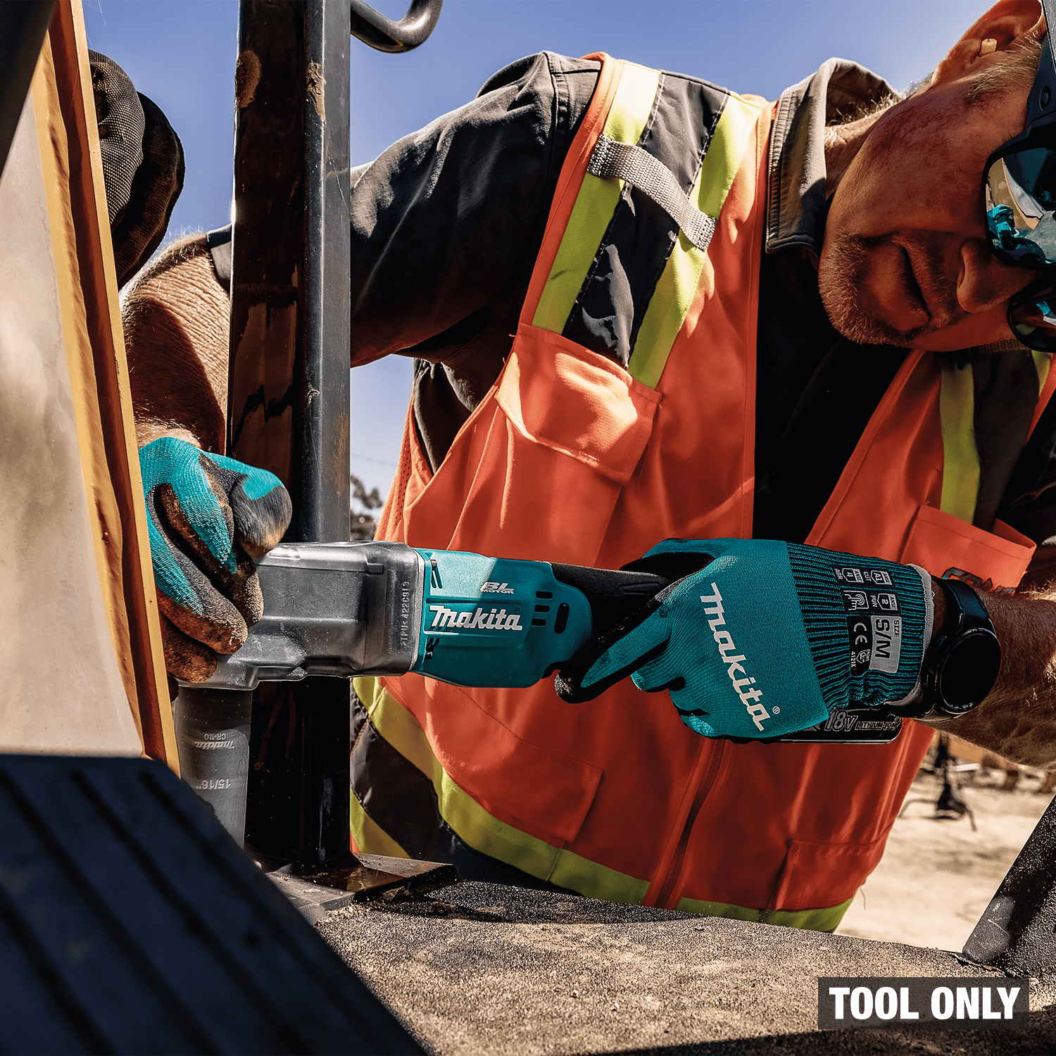 Heavy equipment mechanic tightens machinery bolts in confined spaces using the Makita 18V cordless angle impact wrench.