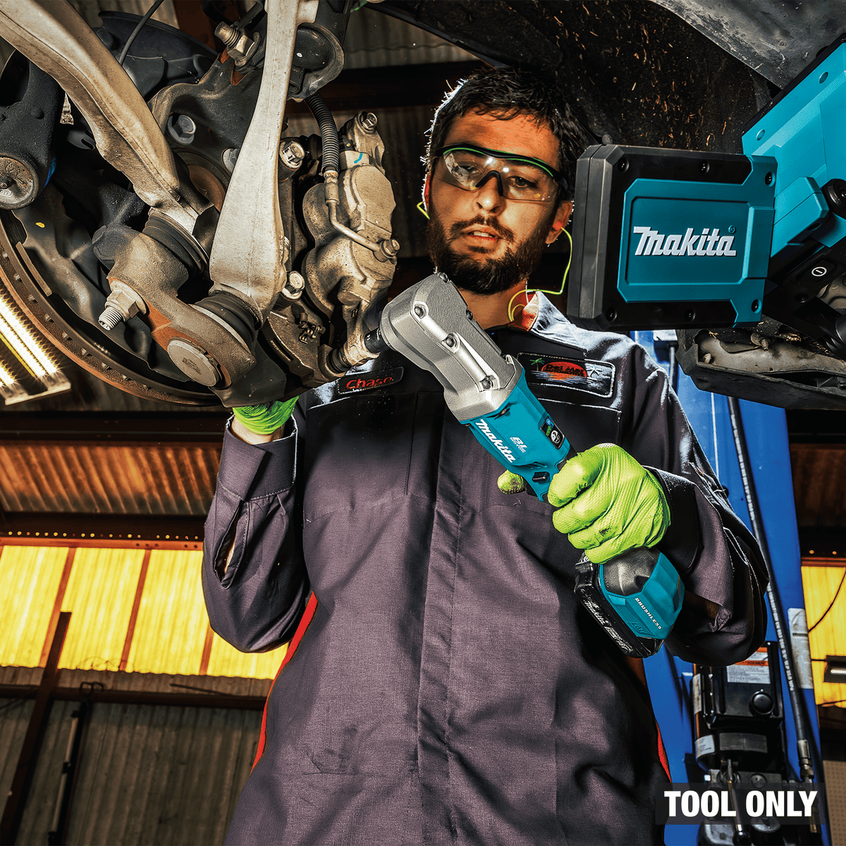 Mechanic removes brake assembly bolts in close quarters with the compact Makita 18V brushless right-angle impact wrench.