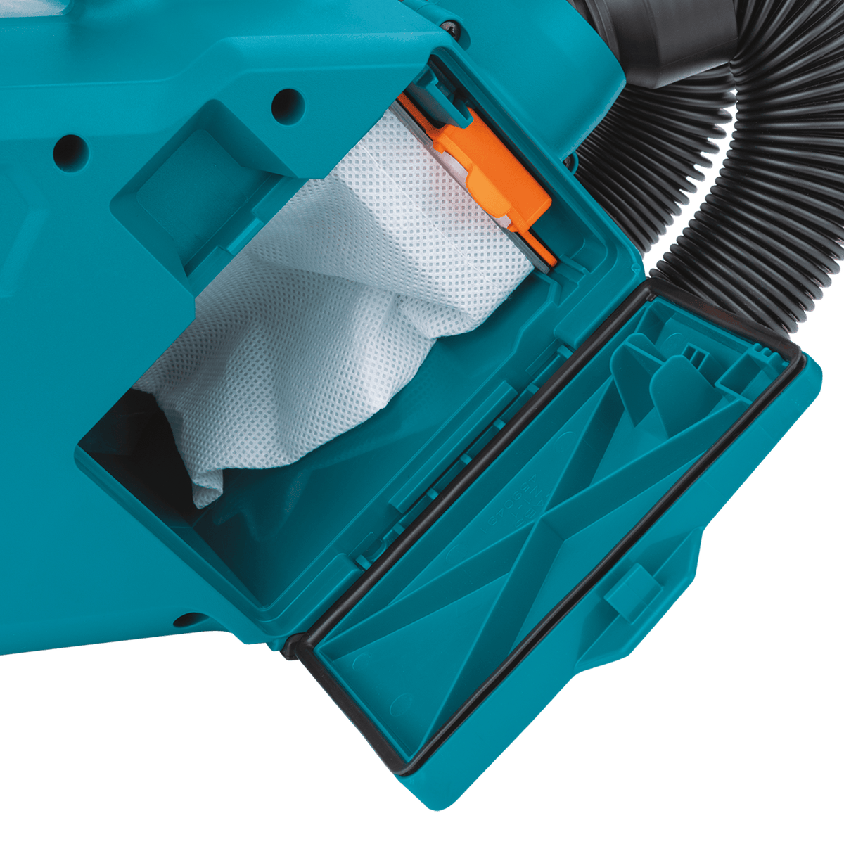 Open side compartment of the Makita XLC07Z vacuum showing the paper filter bag housing and latching mechanism for quick dust bag changes.