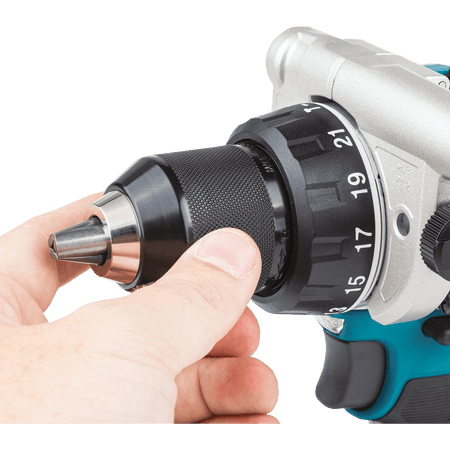 Hand tightening the all-metal 1/2-inch keyless ratcheting chuck on the Makita XPH14 hammer drill for maximum bit retention during heavy drilling.