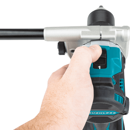 Operator selecting high-speed gear mode 1 on the top-mounted 2-speed transmission switch of the Makita XPH14 hammer driver-drill.