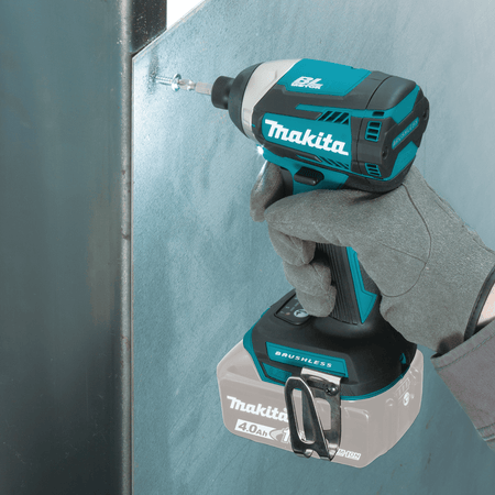 Contractor drives a self-drilling screw into a metal stud using the Makita 18V impact driver with illuminated LED light.
