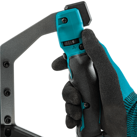 Operator hand adjusting the variable speed dial on the Makita 40V XGT cordless mixer for precise mixing control.